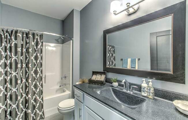 Bathroom with lots of cabinets for storage and a bathtub at The Helen
