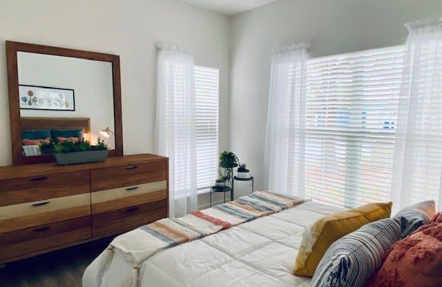 bedroom with a bed and a mirror at Mainstreet Apartments, Clearwater, FL