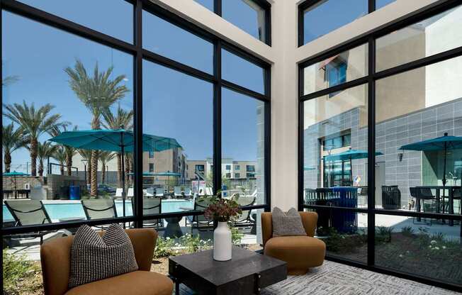 A sunny day at the office with a view of the pool and palm trees.