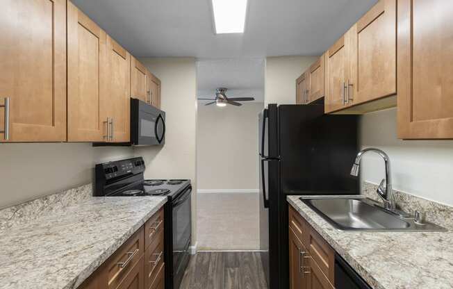 Kitchen with Plank Flooring and Wood Cabinetry at Park Edmonds Apartment Homes, Edmonds, 98026