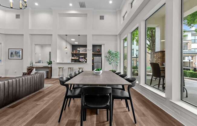 A modern dining room with a wooden table and chairs.