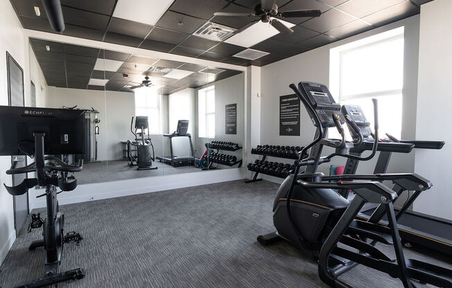 a gym with treadmills and other exercise equipment in a building