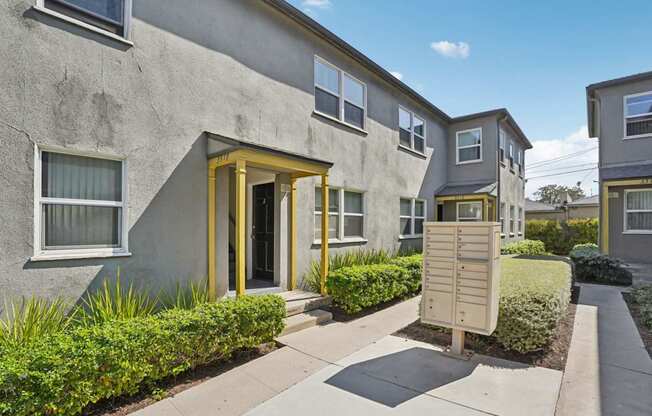 A building with a yellow door and windows with white frames.