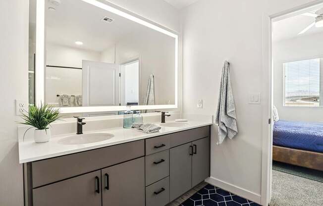 A bathroom with a white sink and a mirror above it.