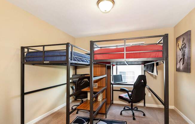 A room with two bunk beds and a desk with a chair at The Landing Apartments and Townhomes, Oregon, 97045