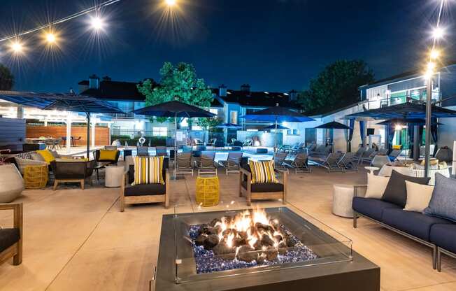 Outdoor fire pit with seating in pool area