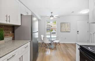 Bright dining nook at Monon Living with ceiling fan and wood-style flooring, located in Broad Ripple near trailheads and local coffee shops.