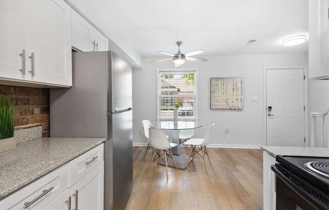 Bright dining nook at Monon Living with ceiling fan and wood-style flooring, located in Broad Ripple near trailheads and local coffee shops.