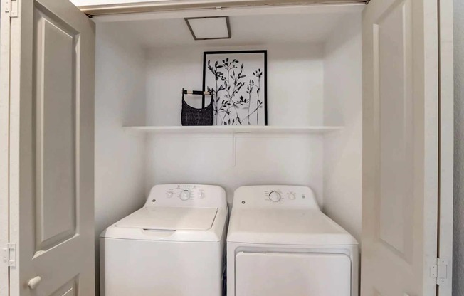 A small laundry room with two washing machines.