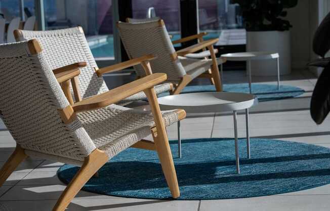 A row of wicker chairs are lined up on a patio.
