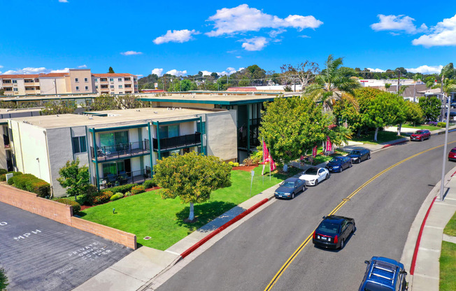 an aerial view of a building with cars parked in front of it at Casa Del Amo Apartments, California