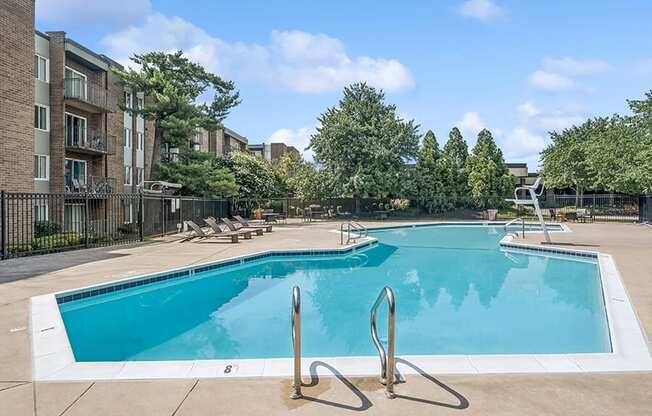 Community Swimming Pool with Pool Furniture at Mason Van Dorn Apartments located in Alexandria, VA.