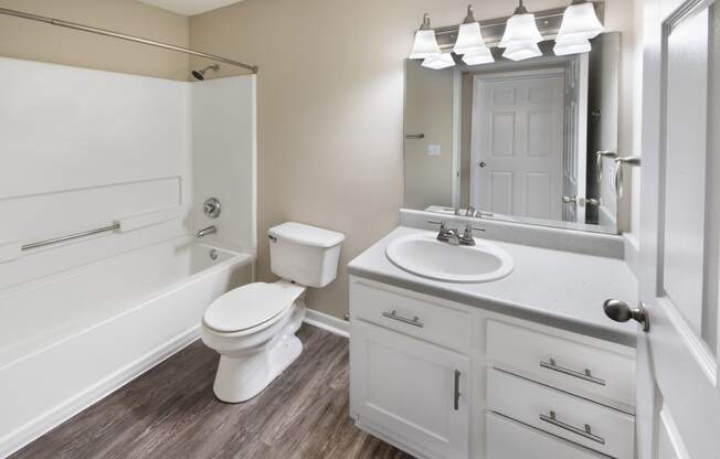 a bathroom with a sink toilet and a bath tub