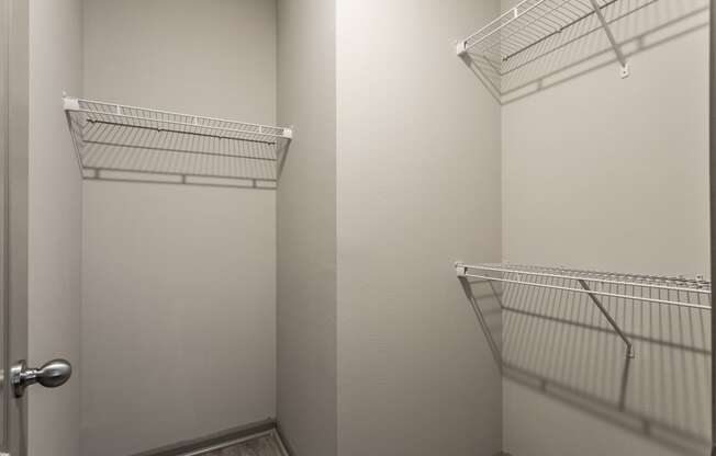 a walk in closet with two white closets and a door