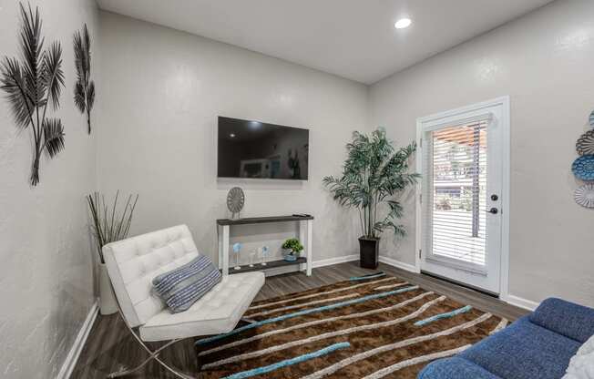 a living room with a couch and a tv on the wall