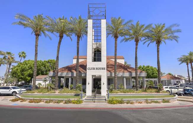 a building with a clock tower in front of palm trees at Vaseo Apartments, Phoenix, AZ 85022