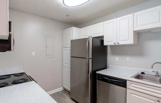 a kitchen with stainless steel appliances and white cabinets