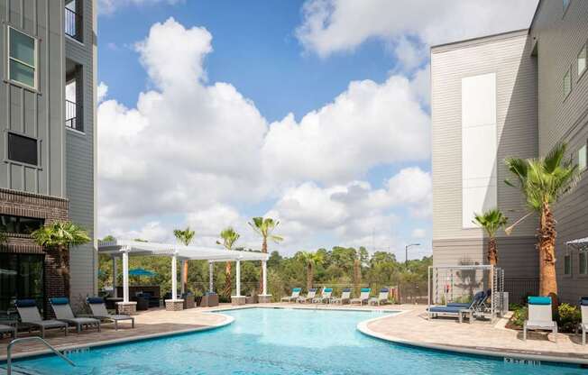 pool view with view of palm trees and clouds