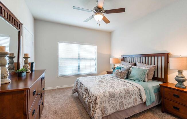 a bedroom with a bed and desk in a room