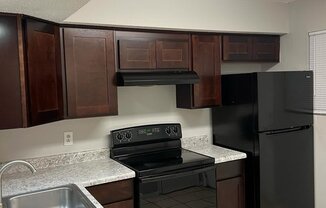 a kitchen with black appliances and granite counter tops