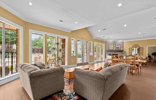 a living room with two couches and a table with chairs