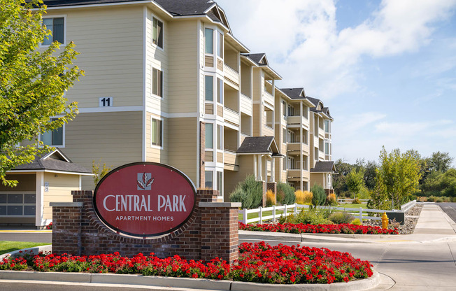an apartment building with a sign that reads central park