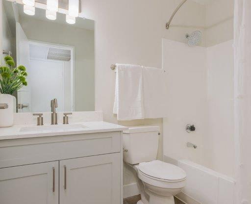 a bathroom with a toilet and a sink and a mirror