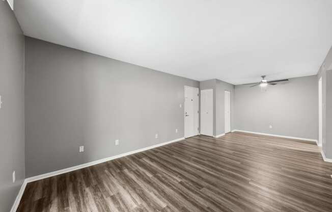 an empty living room with wood floors and grey wallsat The Avalon Apartment Homes, Chesterfield, MO, 63017
