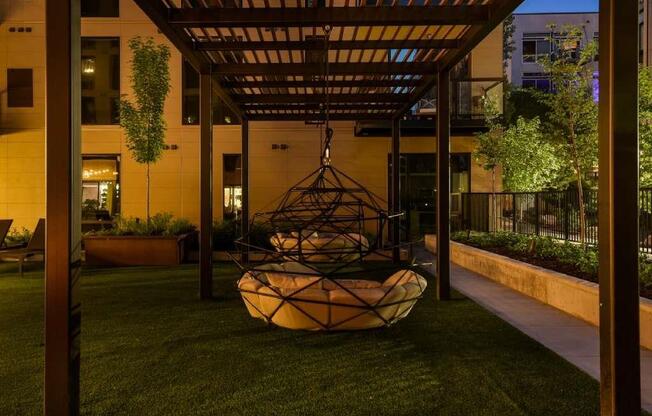 Outdoor courtyard and swings at night