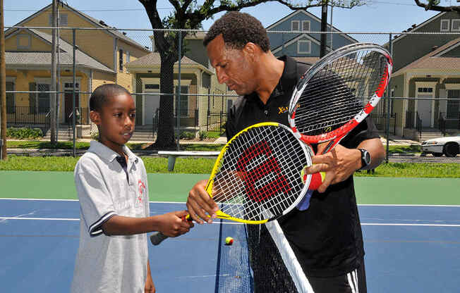 Exterior tennis court with players_Lafitte,New Orleans, LA