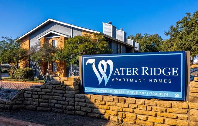 a sign for after ridge apartment homes in front of a brick wall at Water Ridge, Irving, 75061