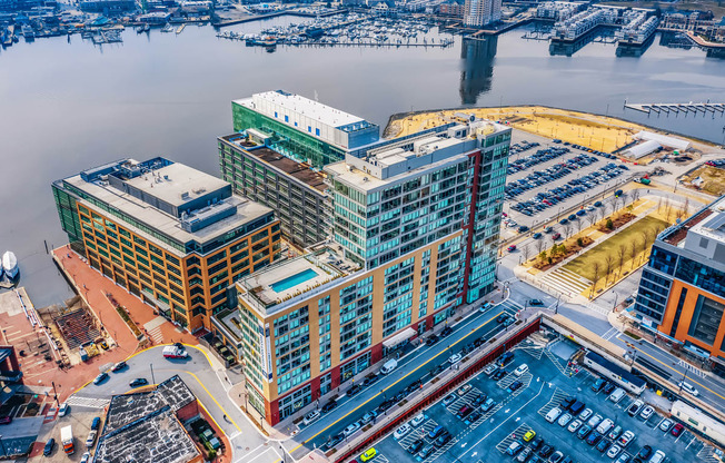 an aerial view of a city with tall buildings and a harbor