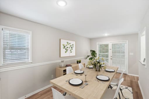 a dining room with a wooden table and chairs