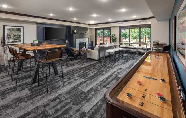 Indoor view of clubhouse equipped with game table and multiple seating areas at The Whitley.