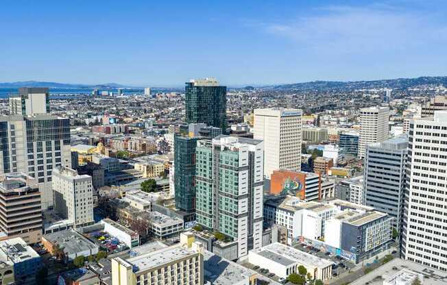 A cityscape with various buildings and a clear sky.