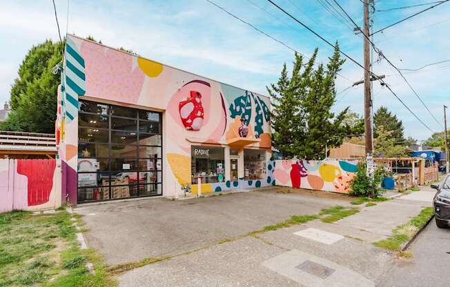 A colorful building with a mural on the side.