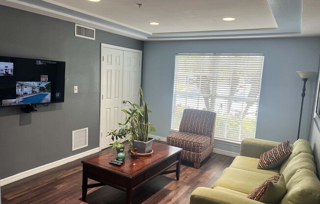 a living room filled with furniture and a flat screen tv