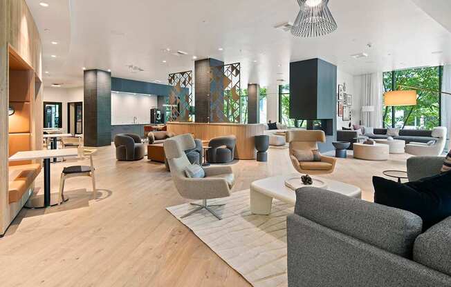 A modern living room with a grey sofa and a wooden floor.