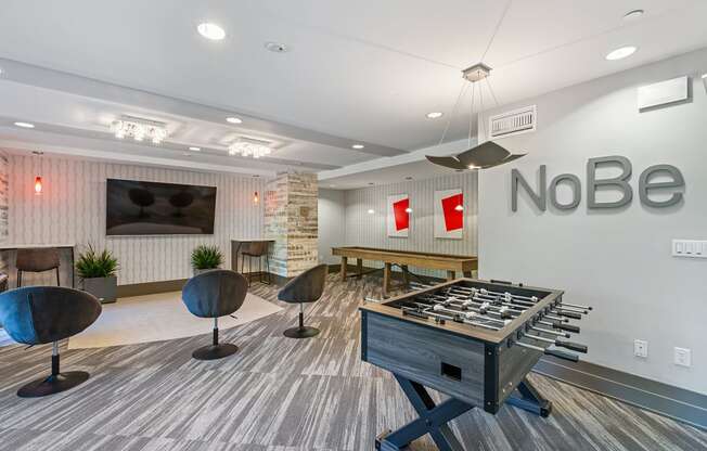 a games room with a foosball table   and a table with chairs