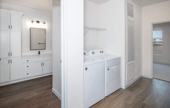 a white laundry room with white appliances and white cabinets at The Crossings at Windsong, Prescott Valley, Arizona