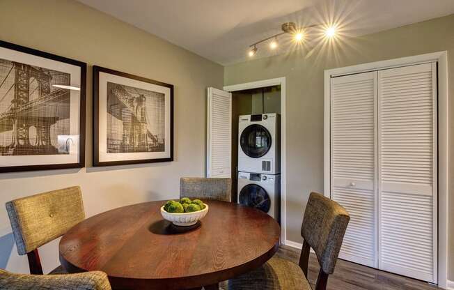 a dining room with a table and chairs and a washing machine