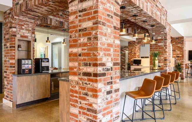 A row of chairs are lined up in front of a brick wall.