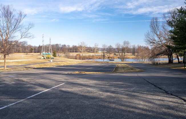 A large open parking lot with a clear blue sky above.