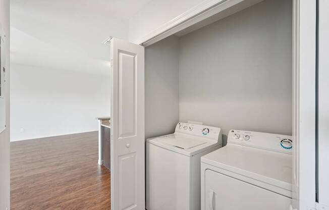 A white washing machine and dryer in a laundry room.