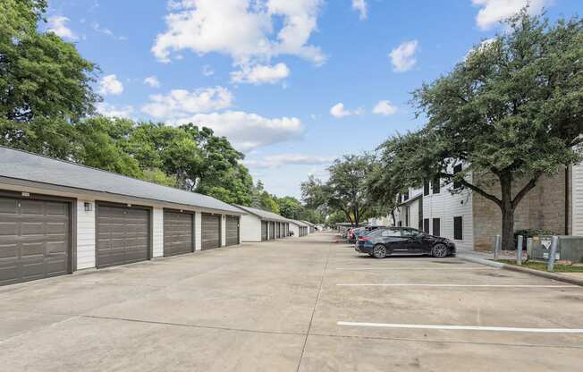parking lot with garages and cars parked
