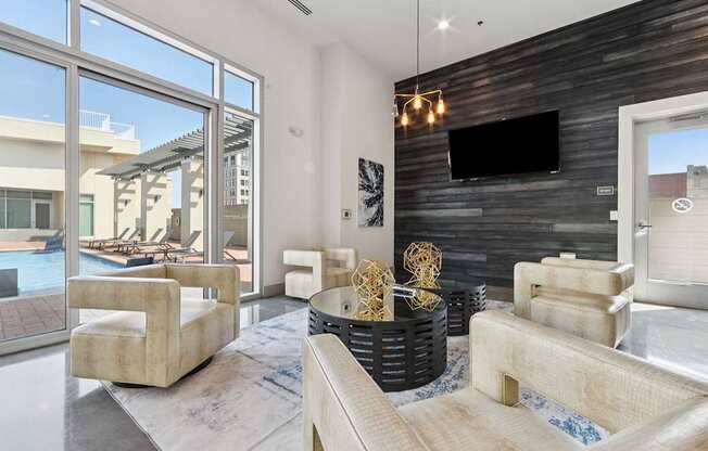 A modern living room with a flat screen TV mounted on the wall.