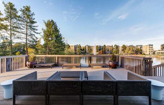 a deck with a fire pit and a view of the city at Ashford Belmar Apartments, Colorado