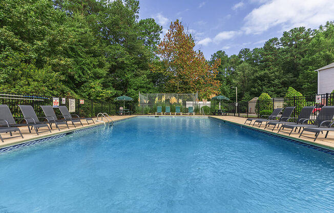 Pool surrounded by landscaping at Greens of Pine Glen in Durham NC