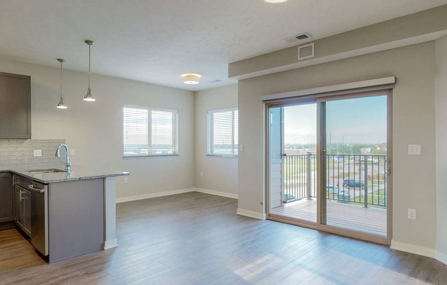 The 2 bedroom Marigold with den floor plan at WH Flats features natural light and a spacious dining and living area with electric fireplace.