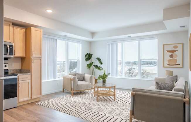 a living room with two couches and chairs and a rug